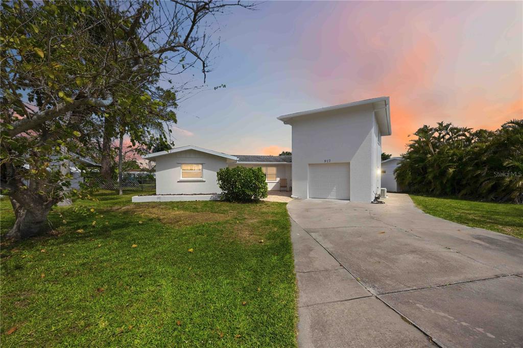 A white single-story house with a prominent attached garage and a concrete driveway — 917 CHURCH STREET, VENICE, FL