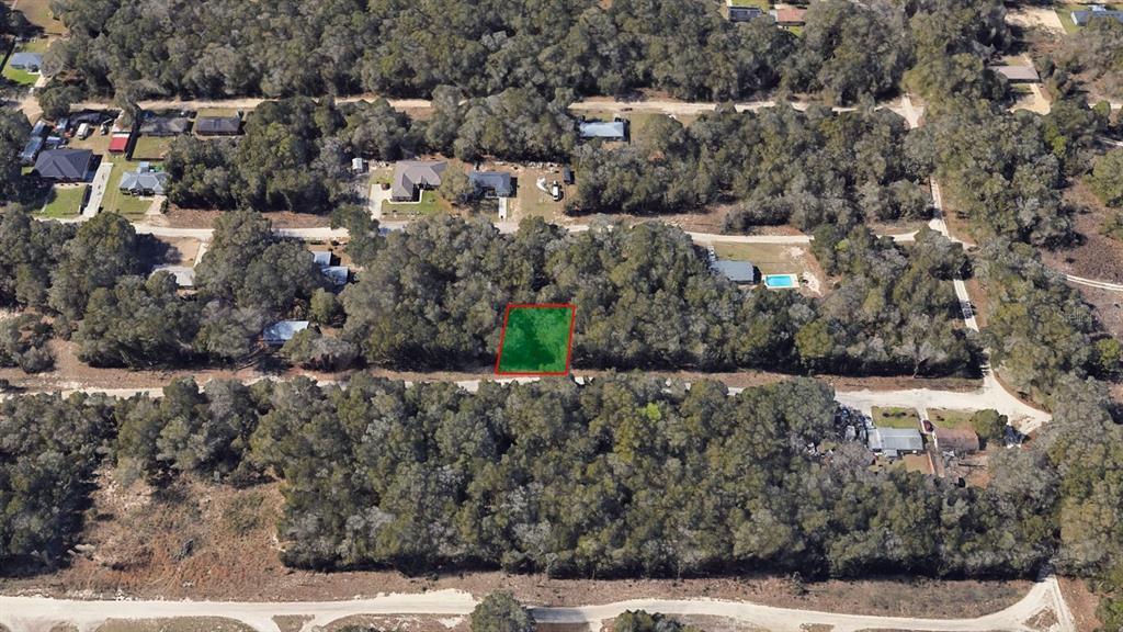 An aerial view shows a rectangular, wooded plot of land highlighted in green — 1398-1000 NW 56TH AVE,, OCALA, FL
