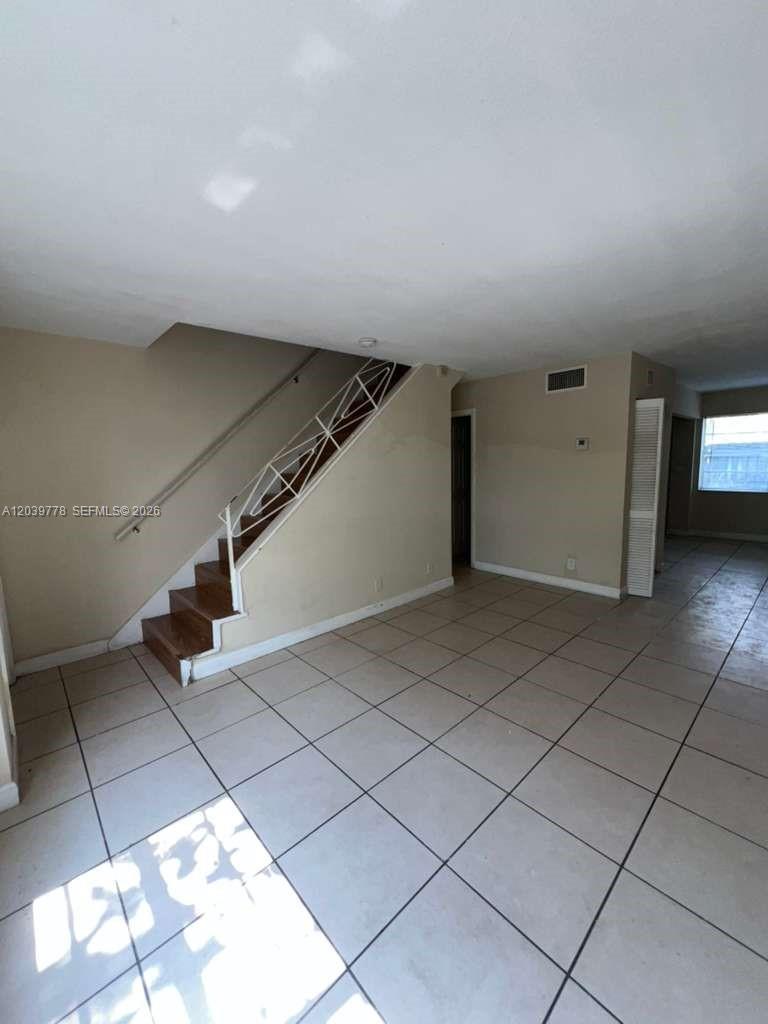 An interior view shows a living area with tiled floors and a staircase — 4625 NW 9th Dr # 4625, Plantation FL 33317, PLANTATION, FL