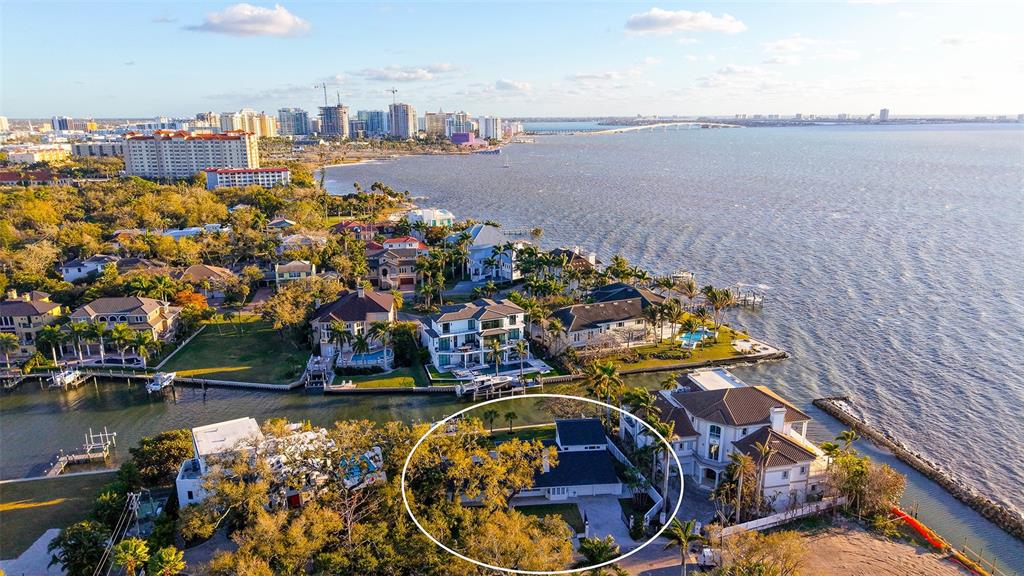 An aerial view shows a residential house surrounded by trees near a waterfront — 940 ALAMEDA WAY, SARASOTA, FL