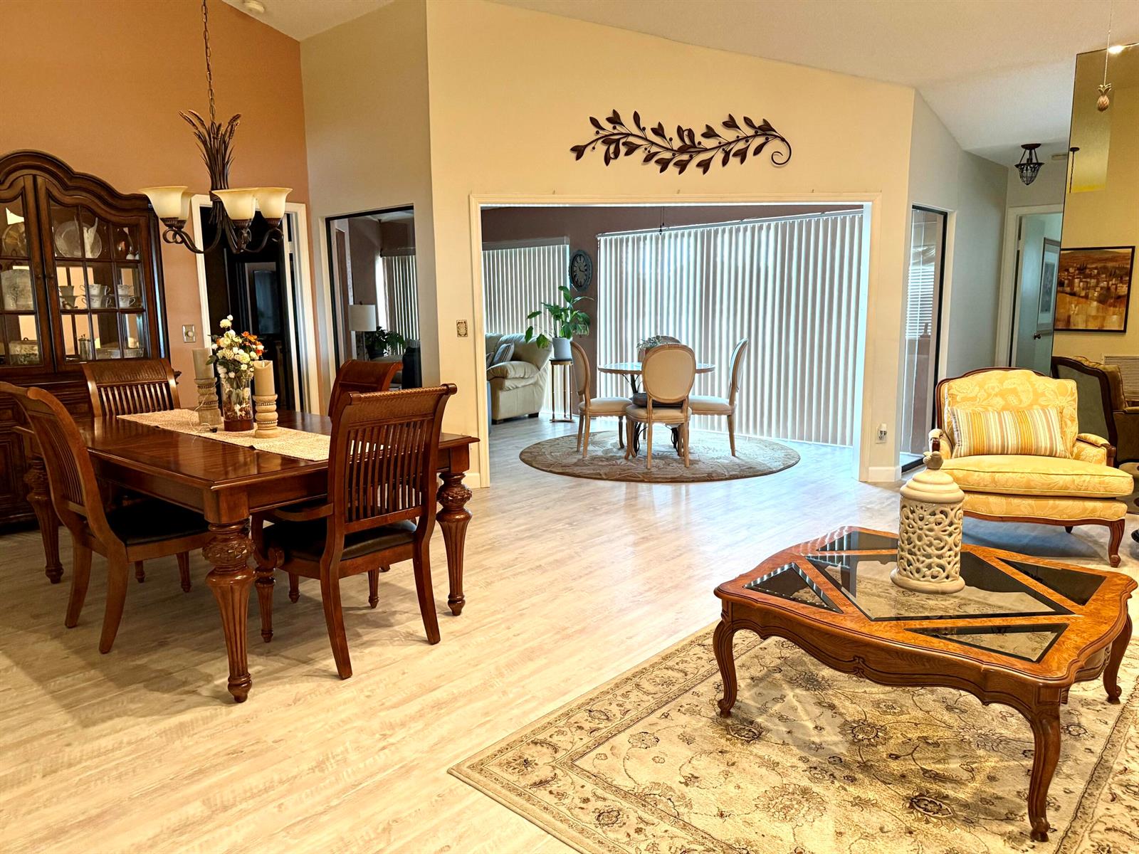 A dining room with a wooden table and hutch opens into a living area with furniture — 5878 Parkwalk Circle W, Boynton Beach FL 33472, BOYNTON BEACH, FL