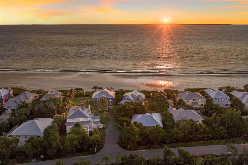 An aerial view of beachfront houses surrounded by trees at sunset — 367 NIGHT HERON DRIVE, BOCA GRANDE, FL
