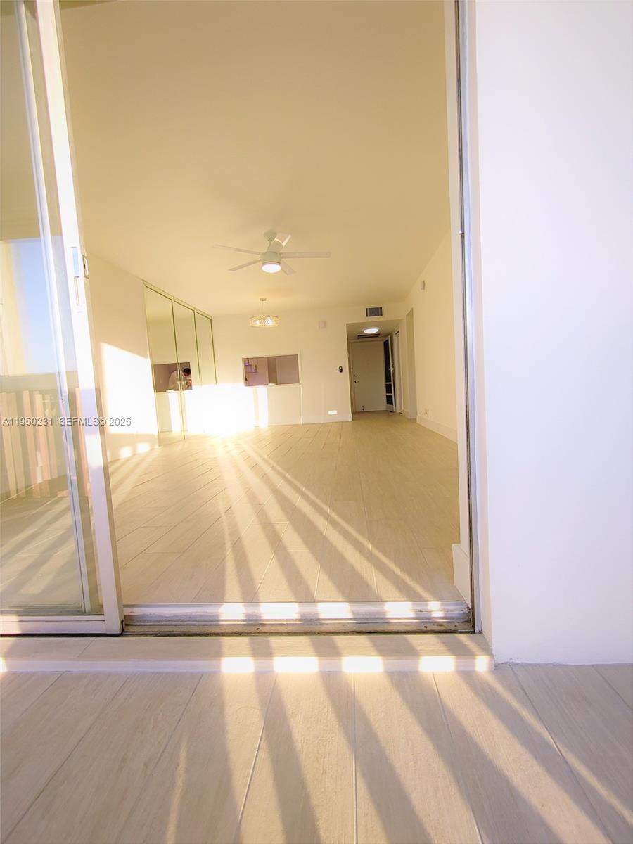 An interior view of a bright, open-plan living area with light-colored tile flooring — 215 SE 3rd Ave # 307C, Hallandale Beach FL 33009, HALLANDALE BEACH, FL