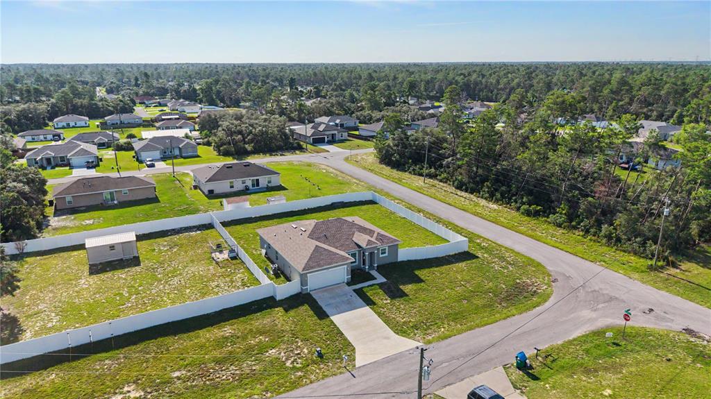 An aerial view shows a single-story house with a fenced yard in a suburban neighborhood — 17199 SW 43RD COURT, OCALA, FL