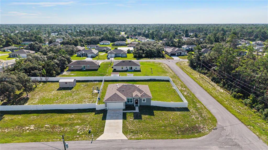 An aerial view shows a single-story house with a fenced yard and concrete driveway — 17199 SW 43RD COURT, OCALA, FL