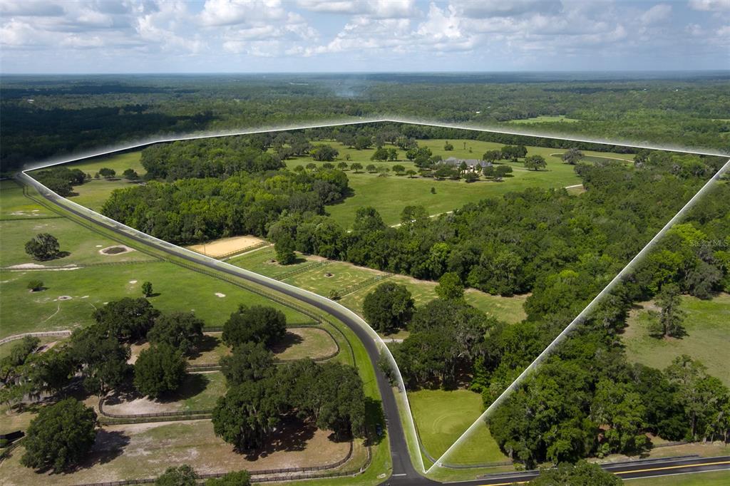 An aerial view shows a large, fenced rural property with a house, trees, and pastures — 9095 NW 200TH STREET ROAD, MICANOPY, FL
