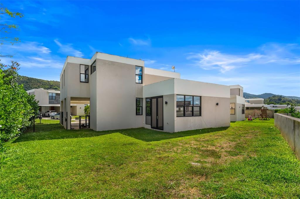 A two-story modern house with a flat roof and a grassy backyard — 109 CALLE DANUBIO, GURABO, PR