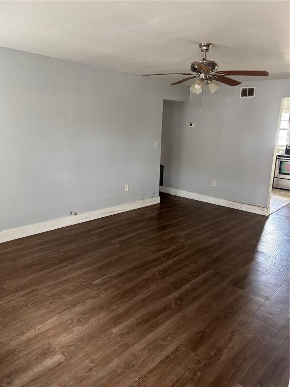 An empty room with light blue walls, dark wood-look flooring, and a ceiling fan — 2779 L B MCLEOD ROAD UNIT A, ORLANDO, FL