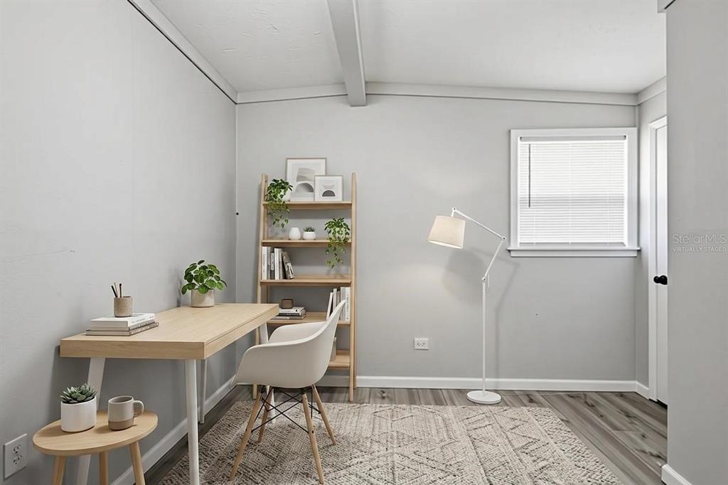 A home office with light wood furniture, a white chair, and a floor lamp — 6727 SANDRA DRIVE, PORT RICHEY, FL