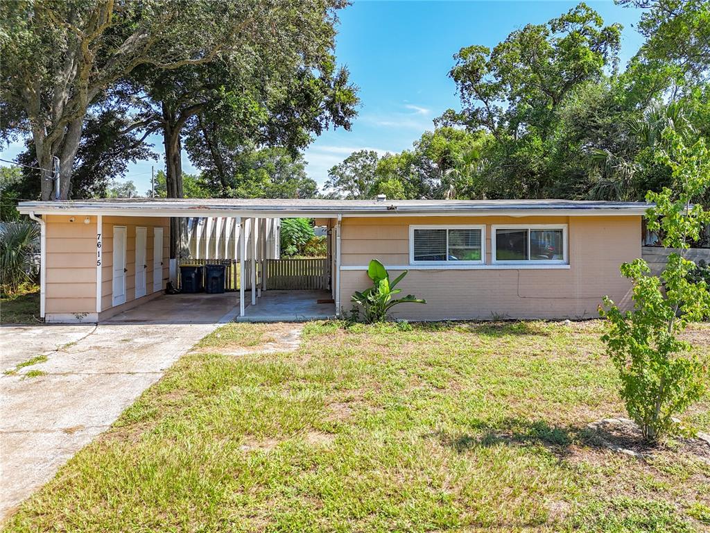 A single-story house with a carport, tan siding, and a concrete driveway — 7615 MAYAPPLE ROAD, JACKSONVILLE, FL