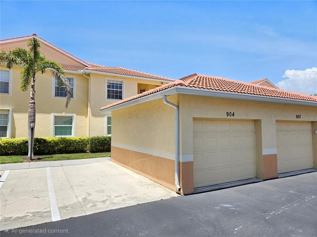 A yellow two-story building with a detached garage featuring numbered doors under a tiled roof — 904 CASA DEL LAGO WAY UNIT 904, VENICE, FL