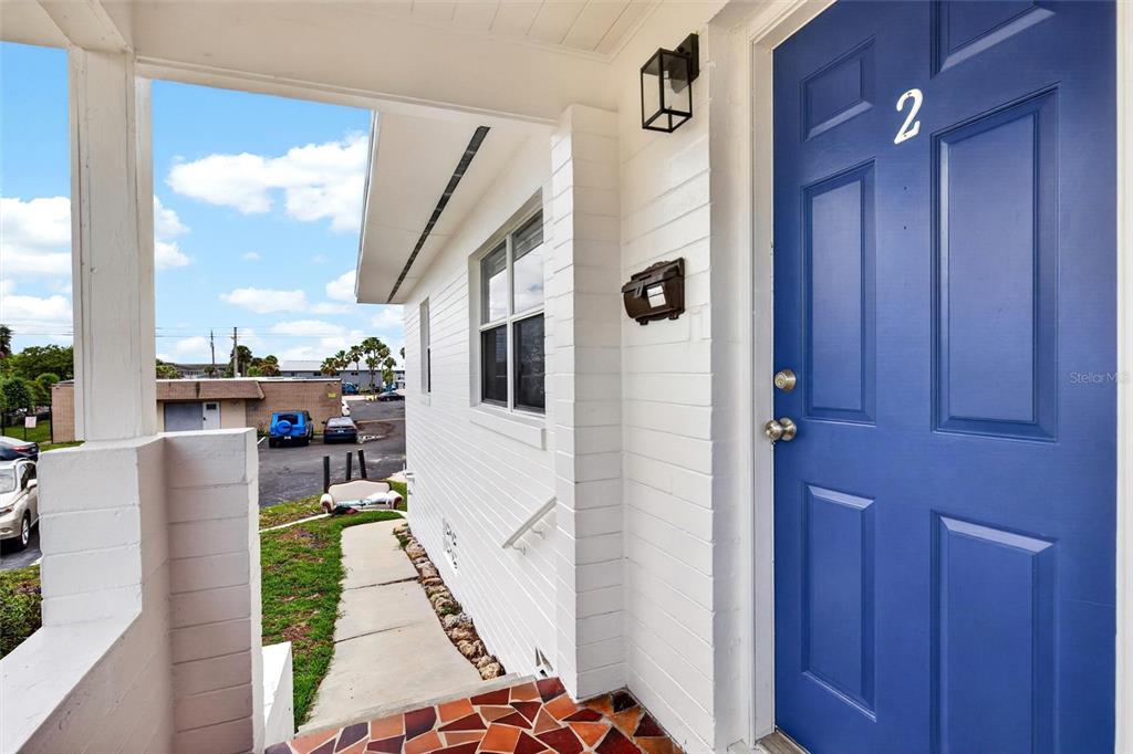 A blue front door with the number two sits on a white brick porch — 419 N PENINSULA DRIVE, DAYTONA BEACH, FL
