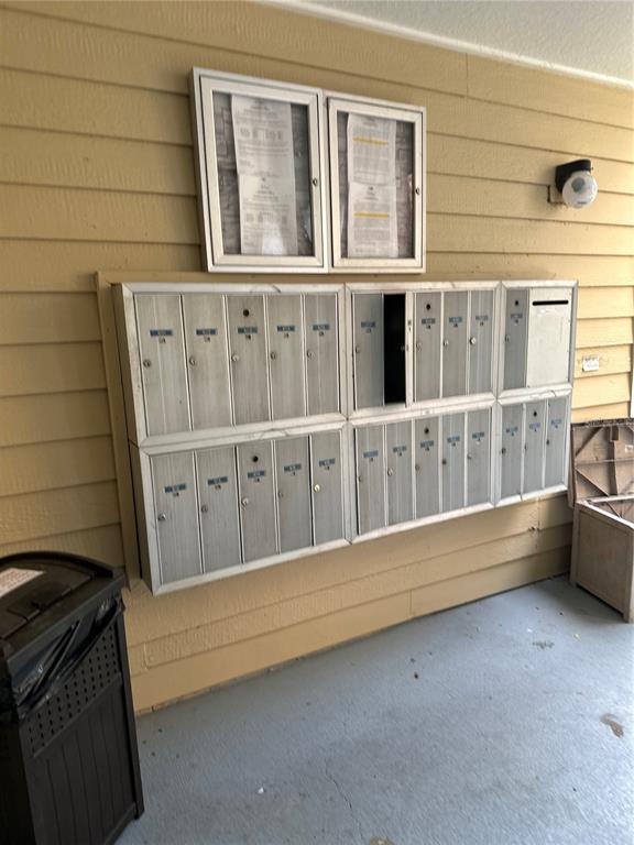 A wall-mounted cluster mailbox unit is positioned on a beige exterior wall — 10024 STRAFFORD OAK COURT UNIT 803, TAMPA, FL
