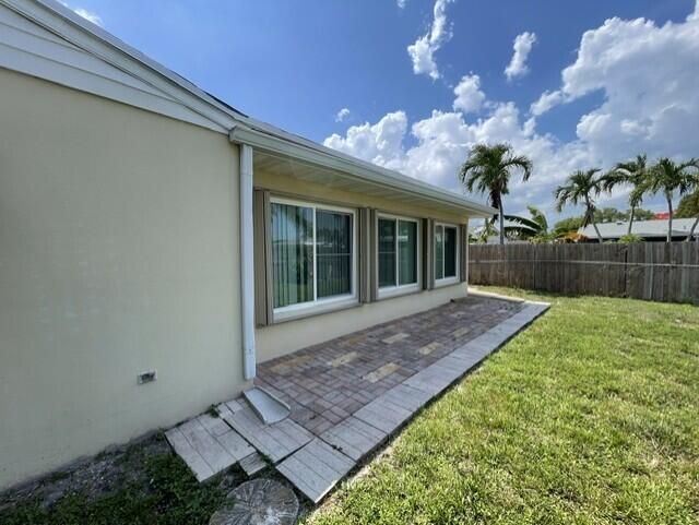A backyard features a wooden fence, a grassy lawn, and two gazebos behind the fence — 180 SW 77th Avenue, Margate FL 33068, MARGATE, FL