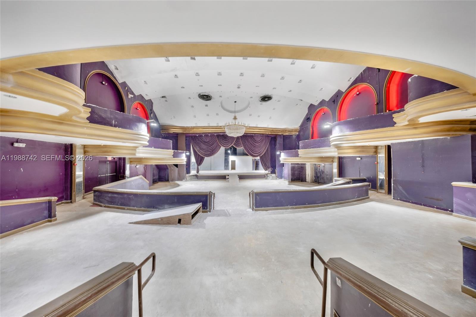 An interior view of a large, vacant event hall with purple walls and gold trim — 5445 Collins Ave, Miami Beach FL 33140, MIAMI BEACH, FL