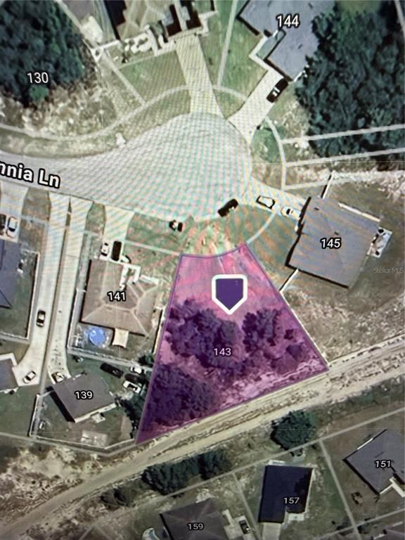 An aerial map view shows a highlighted vacant residential lot situated on a cul-de-sac — 143 ZINNIA LANE W, KISSIMMEE, FL