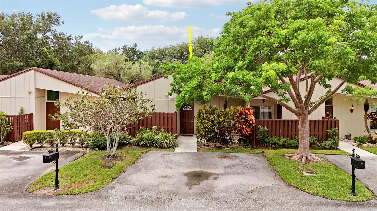 A single-story residential building with a brown roof, tan siding, and a paved driveway — 11606 Orange Blossom Lane, Boca Raton FL 33428, BOCA RATON, FL