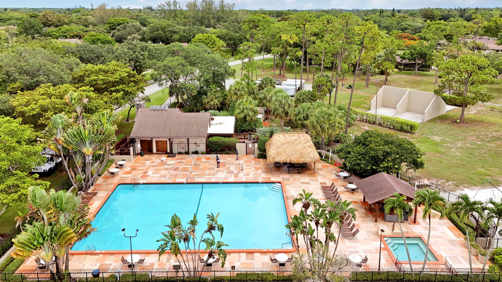 An aerial view shows a swimming pool, a hot tub, and a clubhouse with landscaping — 11606 Orange Blossom Lane, Boca Raton FL 33428, BOCA RATON, FL