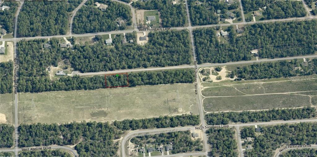 This is an aerial map view showing a rectangular plot of land highlighted in red — 6925 N FOUNTAINHEAD DRIVE, CITRUS SPRINGS, FL
