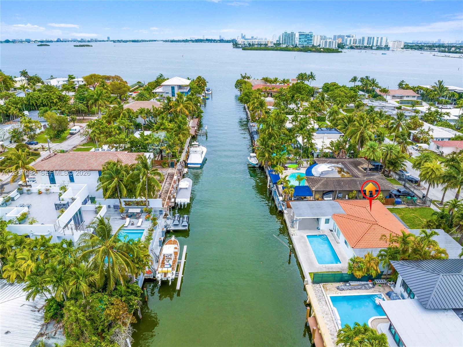 An aerial view shows waterfront homes with private pools and boat docks along a canal — 1161 NE 86th St, Miami FL 33138, MIAMI, FL