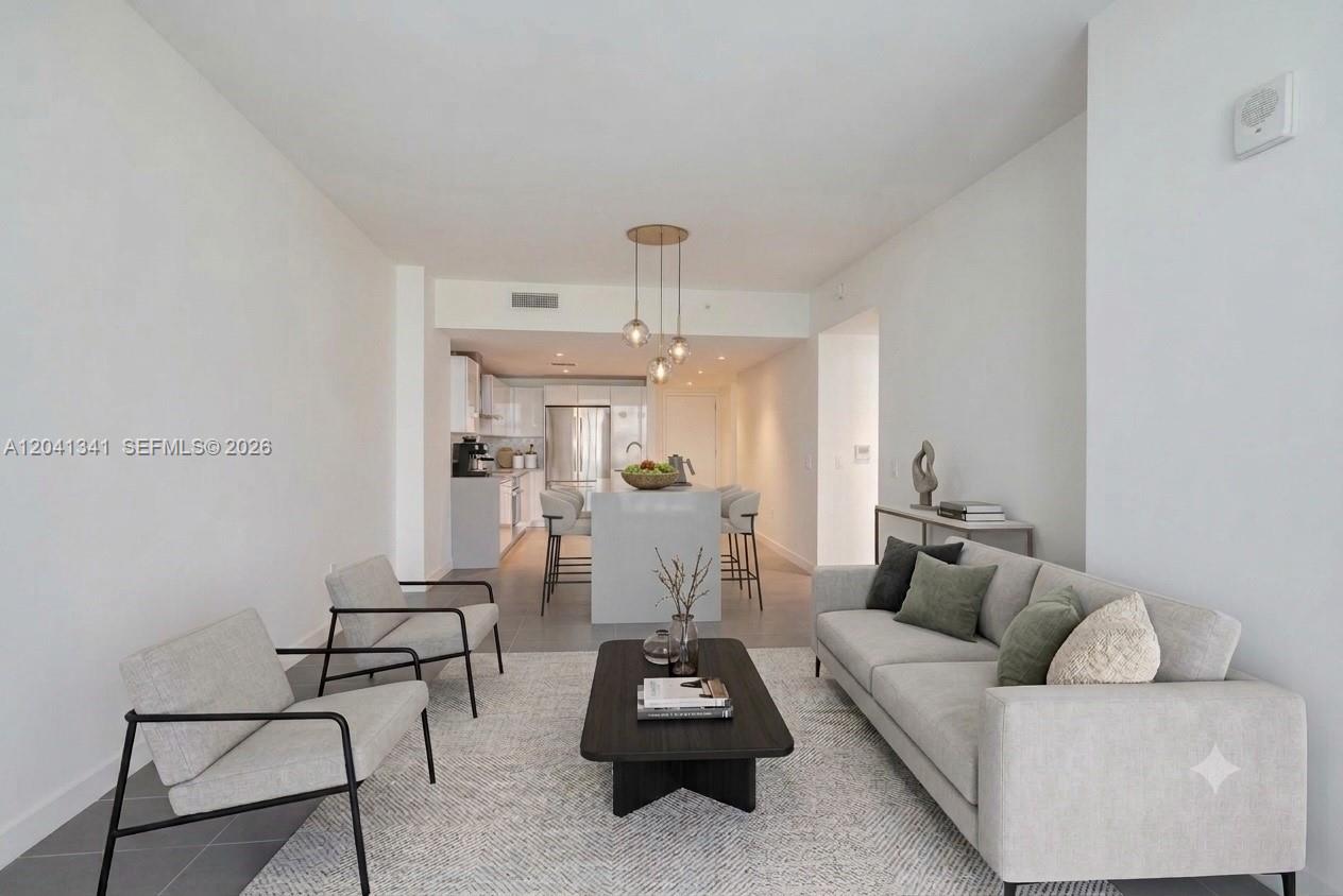 This living room features a sofa, two armchairs, a coffee table, and an open kitchen — 1600 NE 1st Ave # 1401, Miami FL 33132, MIAMI, FL