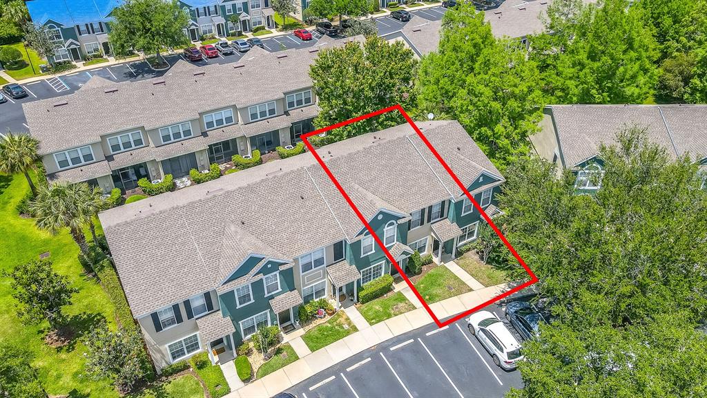 An aerial view shows a two-story townhouse unit highlighted in red within a residential complex — 5338 HAWKSTONE DRIVE, SANFORD, FL
