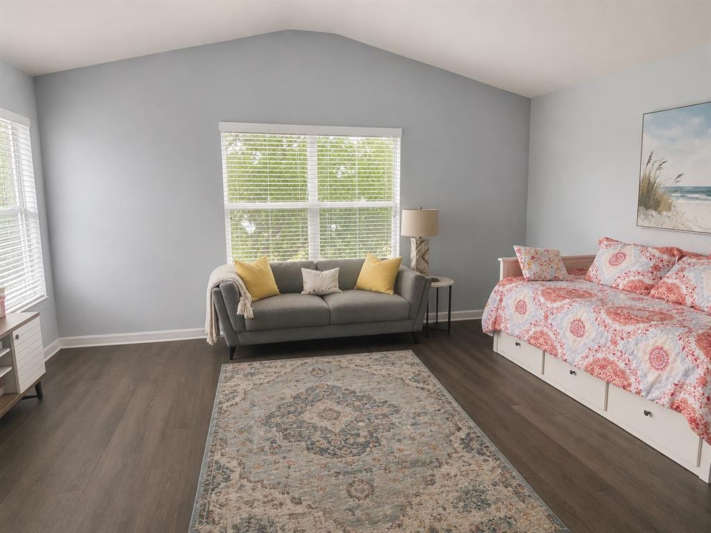 A tiled entryway features a white front door with a sidelight and a cushioned bench — 7717 TANGLE BROOK BOULEVARD, GIBSONTON, FL