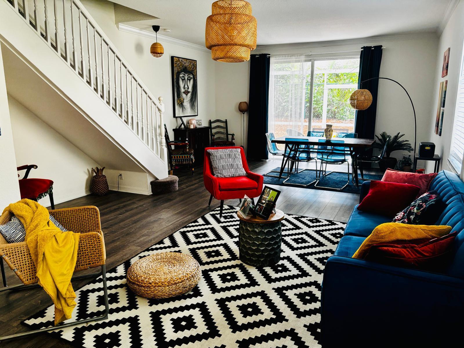 A living and dining area features a blue sofa, red chair, and geometric area rug — 2166 Hacienda Terrace, Weston FL 33327, WESTON, FL