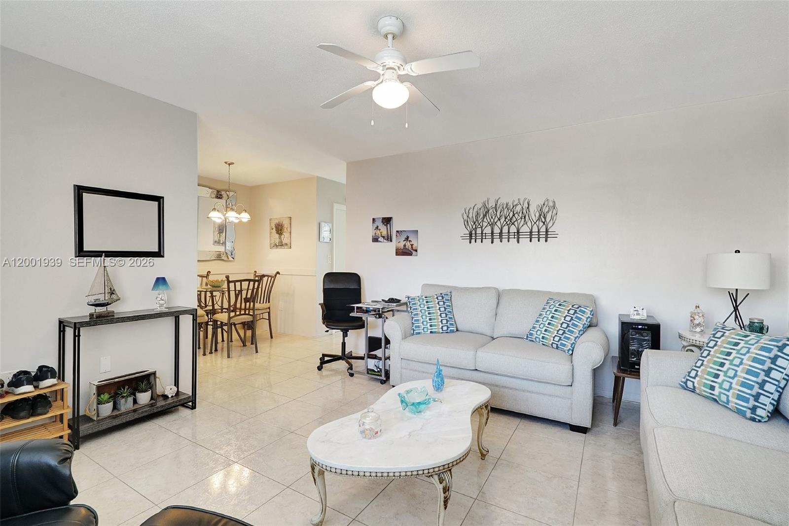 A living room features light tile floors, a white sofa, and a ceiling fan — 16801 NE 13th Ave # 206, Miami FL 33162, MIAMI, FL