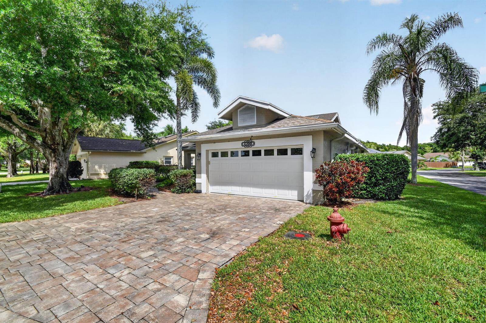 A single-story house with a paved driveway, a two-car garage, and a front lawn — 4200 Grove Park Lane, Boynton Beach FL 33436, BOYNTON BEACH, FL