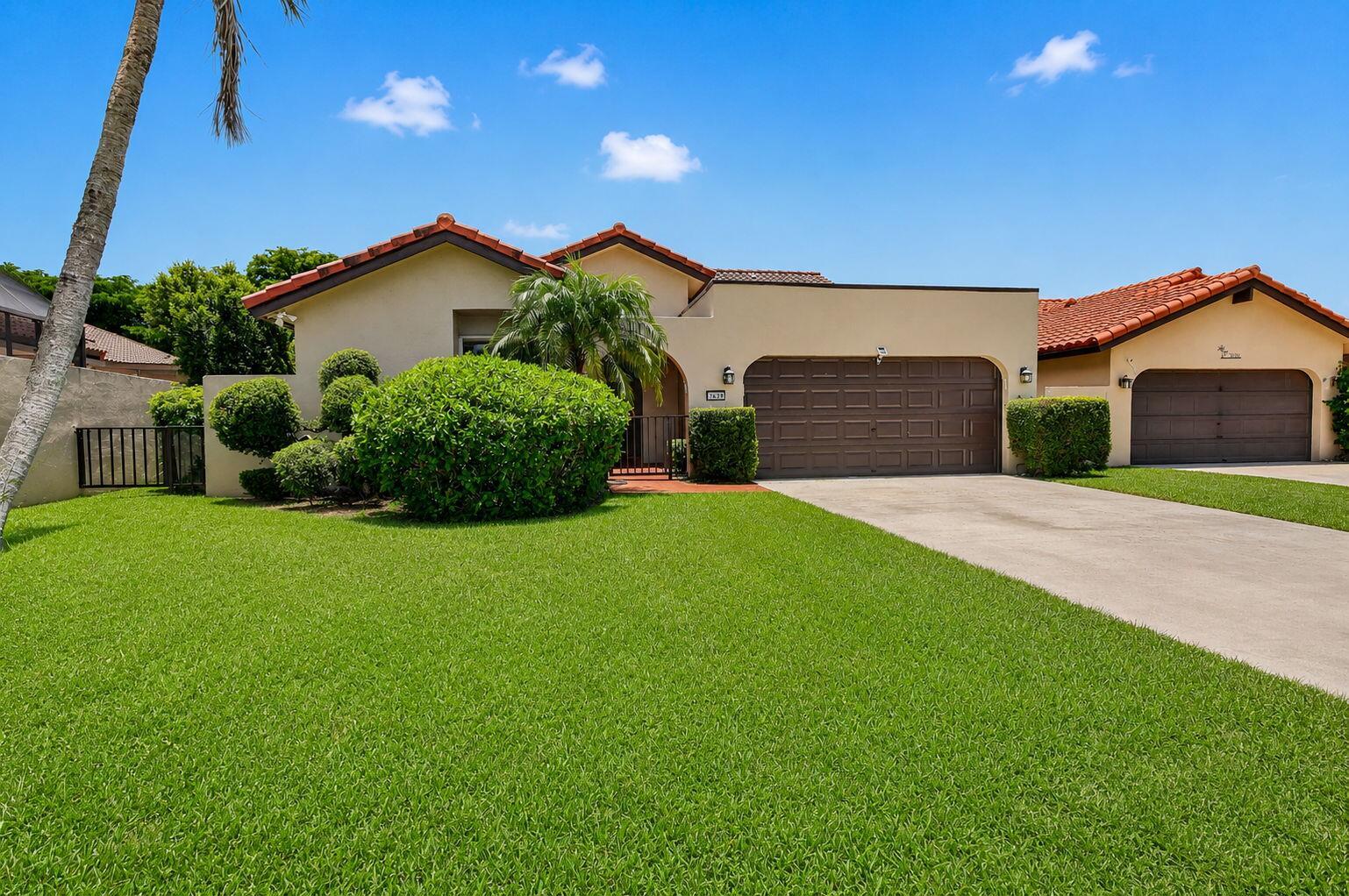 A single-story house with a tan exterior, tiled roof, and a two-car garage — 7690 Solimar Circle, Boca Raton FL 33433, BOCA RATON, FL