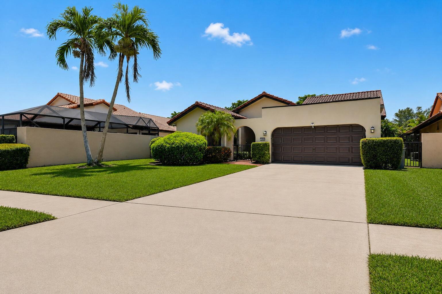 A single-story house with a brown garage door, palm trees, and a concrete driveway — 7690 Solimar Circle, Boca Raton FL 33433, BOCA RATON, FL