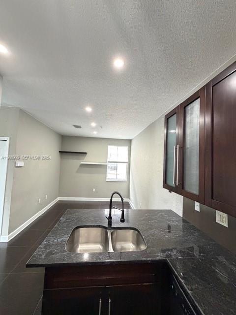 A kitchen island with a double sink and dark countertops faces an open living area — 4331 SW 160th Ave # 218, Miramar FL 33027, MIRAMAR, FL