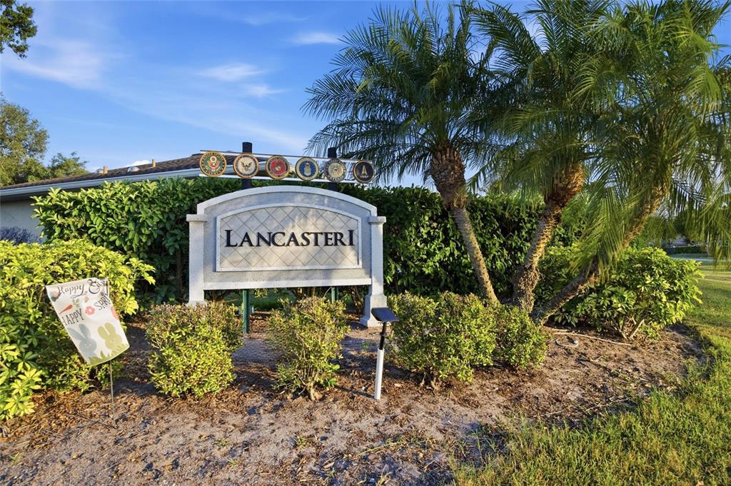 A sign for Lancaster I stands in front of a house with palm trees — 2331 LANCASTER DRIVE, SUN CITY CENTER, FL