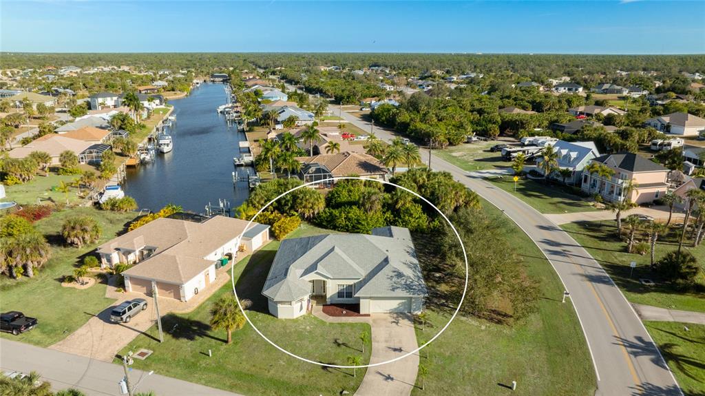 An aerial view shows a single-story house with a gray roof and driveway — 17220 HORIZON LANE, PORT CHARLOTTE, FL