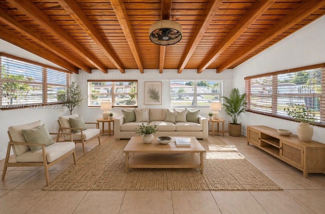 A living room features a wood-beamed ceiling, tile floors, and neutral furniture — 8241 SW 12th Ter, Miami FL 33144, MIAMI, FL
