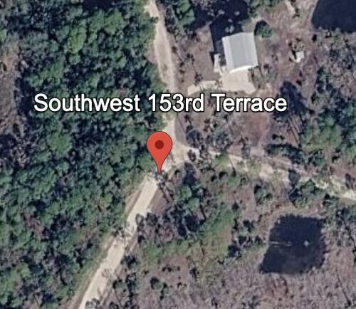 This is a satellite map view showing a dirt road, trees, and a small building — 0 SW 153rd Terrace, FL 32625, FL
