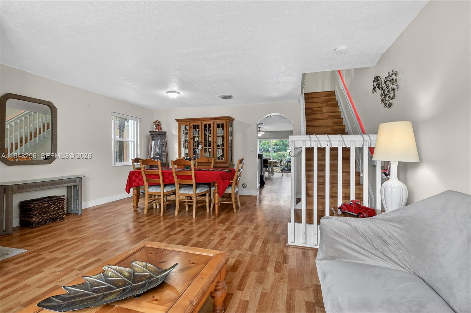 A dining area with a wooden table and hutch sits next to a staircase — 3160 SW 129th Ter # 118, Miramar FL 33027, MIRAMAR, FL