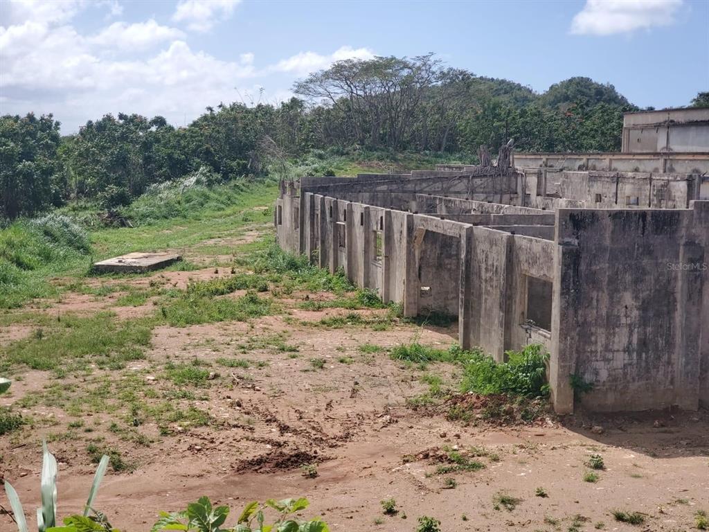 An exterior view of a concrete building shell under construction on a grassy lot — 670 N COTO SUR, MANATI, PR