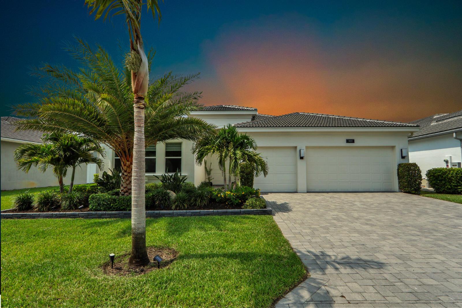 A single-story house with a paved driveway, two-car garage, and palm trees in the yard — 9939 Great Barrier Trail, Boynton Beach FL 33473, BOYNTON BEACH, FL