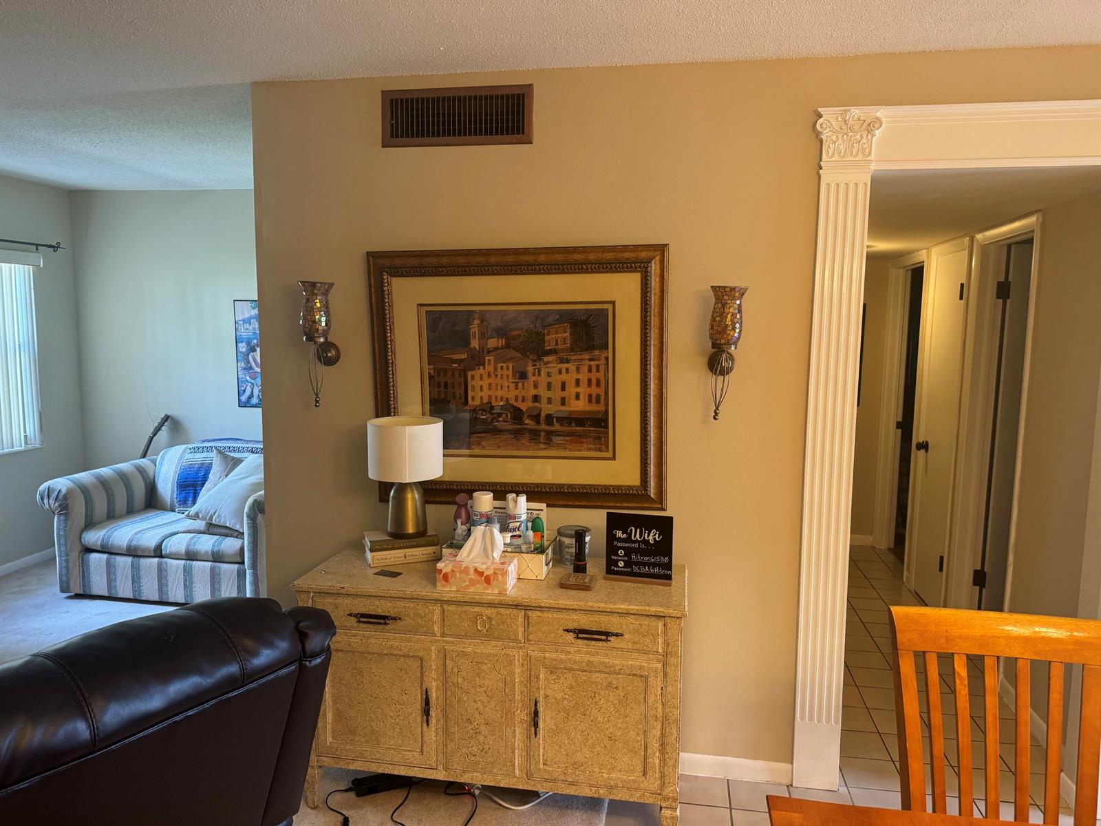 A console table sits against a wall between a living area and a hallway — 5501 NW 2nd Avenue, Boca Raton FL 33487, BOCA RATON, FL