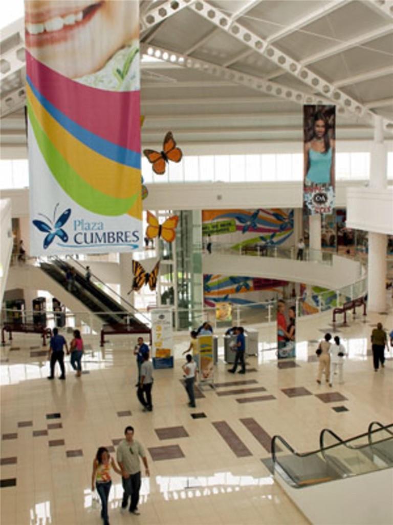 An interior view of a multi-level shopping mall with hanging banners and decorative butterfly cutouts — Lot E-7a Calle Del Cerro Con La Calle Diagonal, Las Cumbres, FL