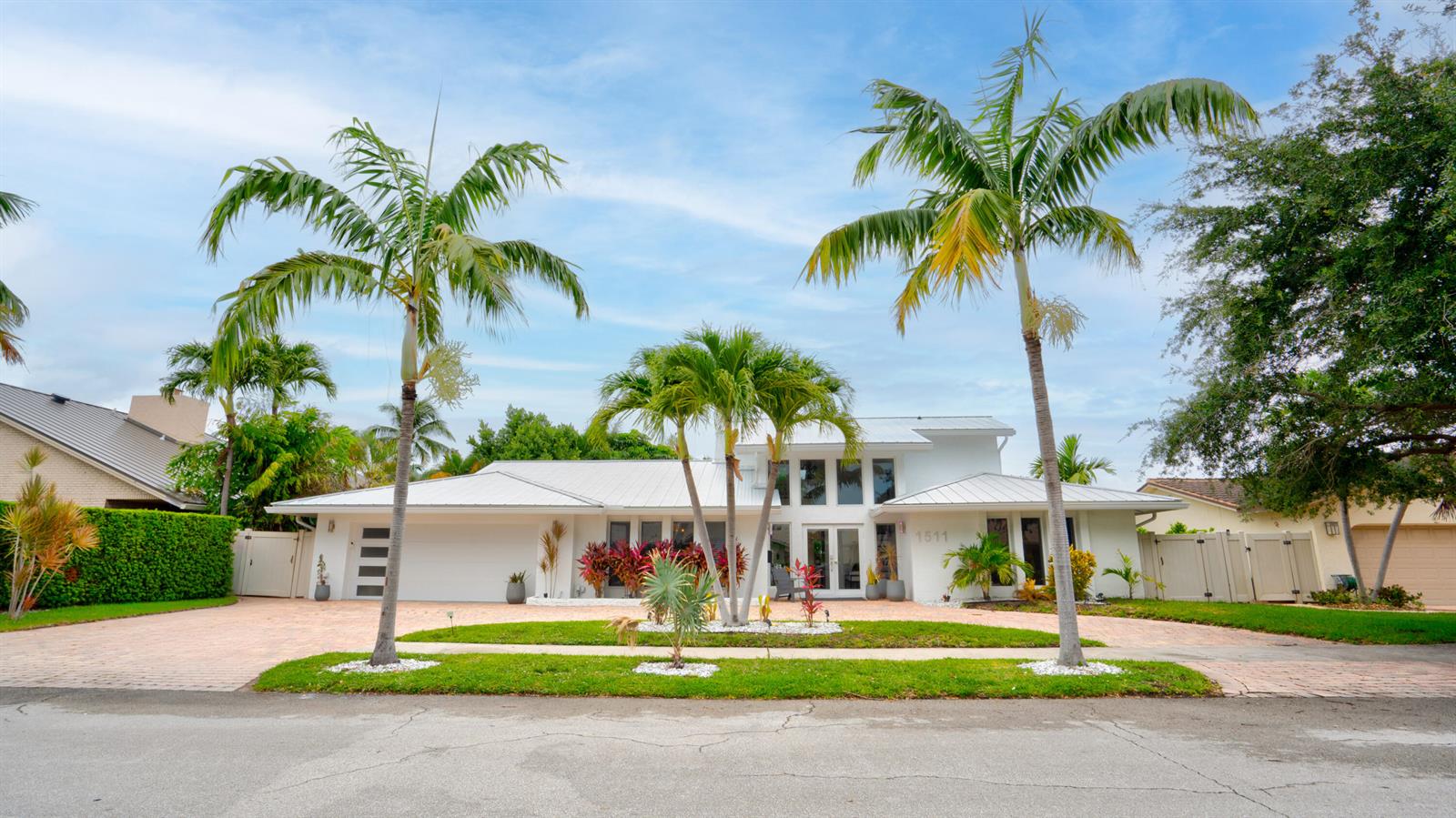 A white single-story house with a metal roof and palm trees in the front yard — 1511 SE 12th Court, Deerfield Beach FL 33441, DEERFIELD BEACH, FL