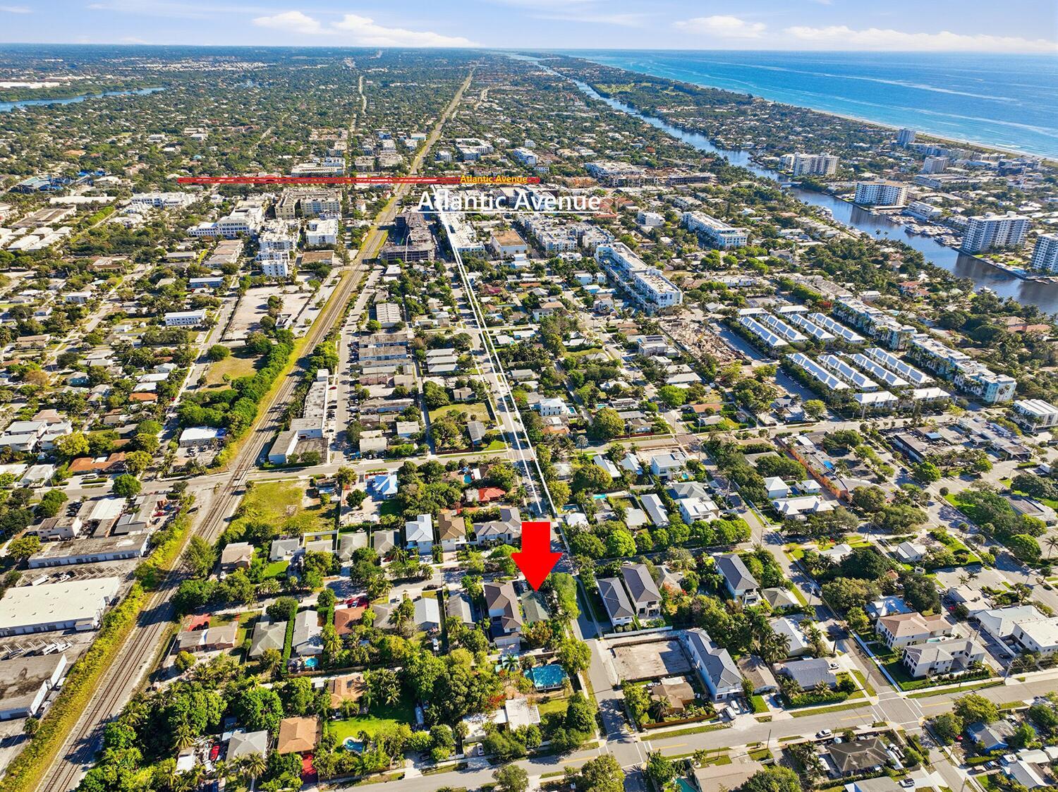 An aerial view shows a residential neighborhood with a red arrow pointing to a house — 502 SE 3rd Avenue, Delray Beach FL 33483, DELRAY BEACH, FL