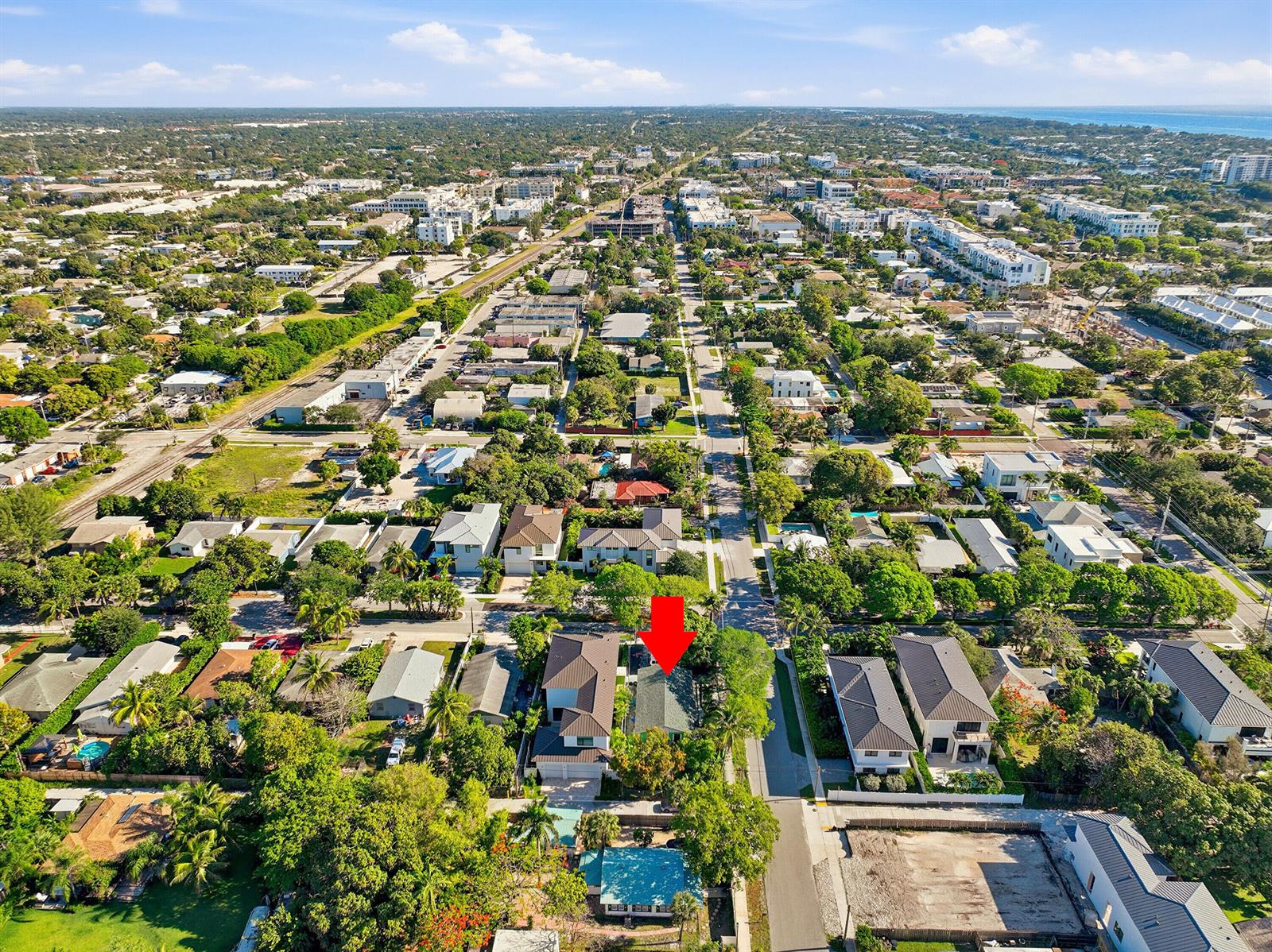 An aerial view shows a residential neighborhood with a red arrow pointing to a house — 502 SE 3rd Avenue, Delray Beach FL 33483, DELRAY BEACH, FL