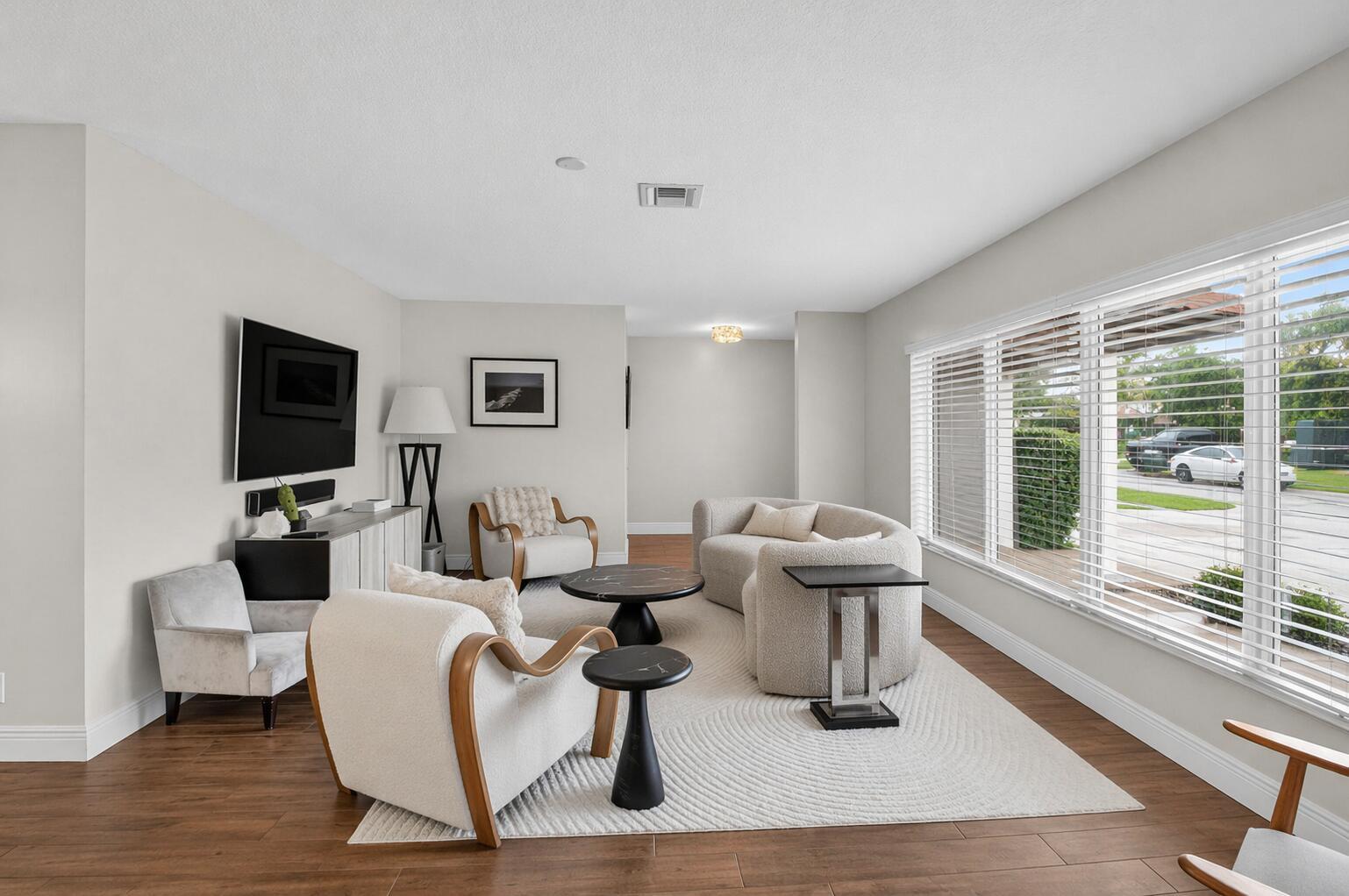 A living room features light-colored furniture, a textured area rug, and large windows with blinds — 650 SW 16th Street, Boca Raton FL 33486, BOCA RATON, FL