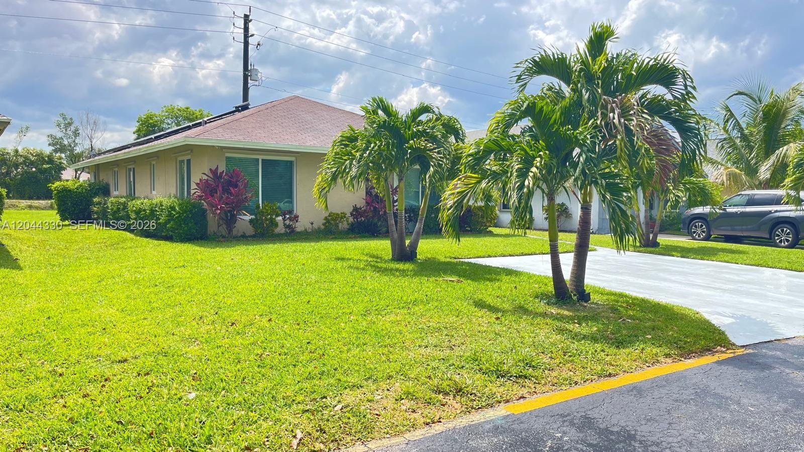 A single-story house with a light-colored exterior, a tiled roof, and palm trees in front — 1359 Summit Run Cir, West Palm Beach FL 33415, WEST PALM BEACH, FL