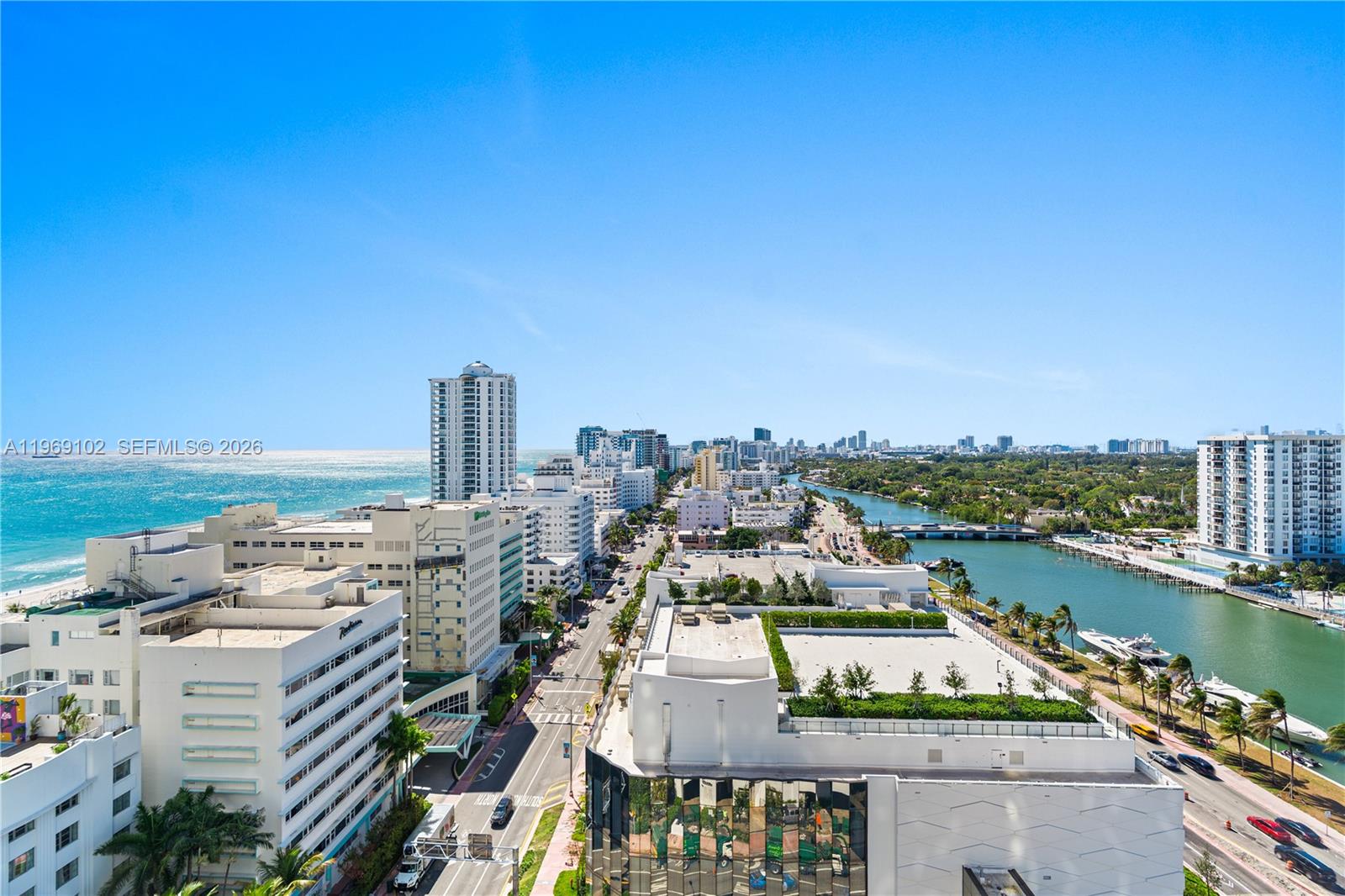 An elevated view of a coastal city featuring buildings, a road, and a waterway — 4401 Collins Ave # 1706, Miami Beach FL 33140, MIAMI BEACH, FL