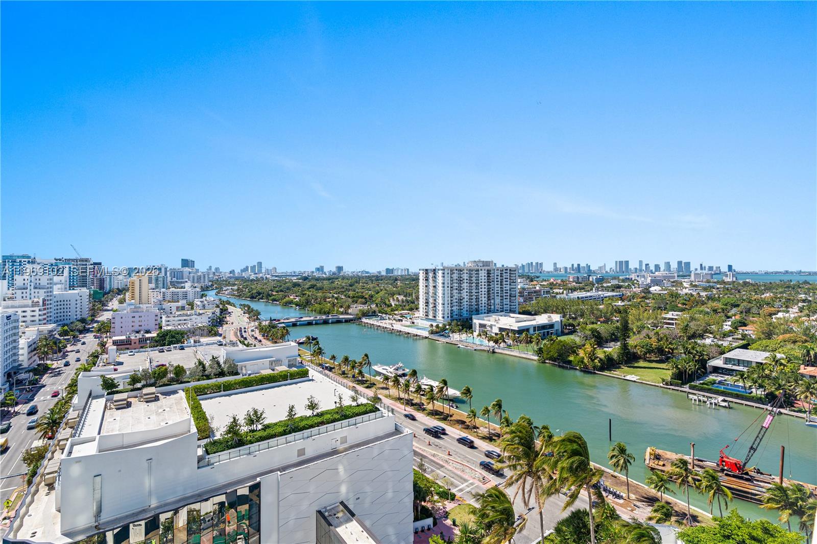 An elevated view of a waterway, city skyline, and surrounding buildings under a clear sky — 4401 Collins Ave # 1706, Miami Beach FL 33140, MIAMI BEACH, FL