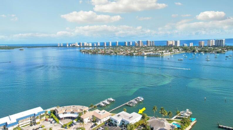 An aerial view of a waterfront building complex with a yellow arrow pointing to a unit — 360 Wilma Circle # 5, Riviera Beach FL 33404, RIVIERA BEACH, FL